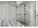 Modern bathroom with a glass enclosed shower, marble surround and built in bench at 7233 15Th Ne Ct, St Petersburg, FL 33702