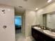This bathroom features dual sinks with a connecting shower and bedroom to promote convenience and privacy at 13621 Willow Bluestar Loop, Riverview, FL 33579
