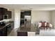 Contemporary kitchen with granite countertops, a central island, and stainless steel appliances at 13621 Willow Bluestar Loop, Riverview, FL 33579