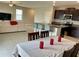 Modern kitchen with a breakfast bar overlooking a dining area and a glimpse of the living space at 13621 Willow Bluestar Loop, Riverview, FL 33579