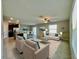 Open-concept living room flows seamlessly into the kitchen and dining areas, perfect for entertaining at 13621 Willow Bluestar Loop, Riverview, FL 33579
