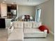 Comfortable sectional sofa positioned near the kitchen and dining area for easy living at 13621 Willow Bluestar Loop, Riverview, FL 33579