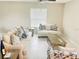 A living room that includes multiple sofas and chairs with a glass top center table, perfect for entertaining guests at 13621 Willow Bluestar Loop, Riverview, FL 33579