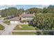Beautiful two-story home showcasing lush landscaping, a two-car garage, and a driveway with sidewalk access at 13945 75Th Ave, Seminole, FL 33776
