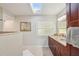 Bright bathroom featuring double sinks, a vanity, and a skylight providing natural light at 13945 75Th Ave, Seminole, FL 33776
