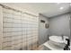 Neutral bathroom featuring a shower with a lined curtain, sleek vanity, and soft lighting for a clean aesthetic at 13945 75Th Ave, Seminole, FL 33776