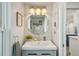 Bathroom featuring a round mirror, vanity with a sink, and modern lighting fixtures at 13945 75Th Ave, Seminole, FL 33776