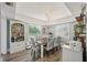 Light-filled dining room features modern decor, a stylish chandelier, and an adjacent cabinet for storage at 13945 75Th Ave, Seminole, FL 33776