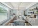 Well-lit dining room with an elegant chandelier, seating for eight, and decorative shelves at 13945 75Th Ave, Seminole, FL 33776