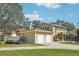 Spacious home exterior with a detached two-car garage, driveway, and well-maintained landscaping at 13945 75Th Ave, Seminole, FL 33776