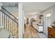 Hallway view to the stairs, dining, and kitchen areas showcasing the open floor plan and lots of light at 13945 75Th Ave, Seminole, FL 33776
