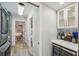 Hallway with wine fridge, glassware cabinet, and doorway views to other rooms at 13945 75Th Ave, Seminole, FL 33776