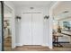 Hallway with bi-fold closet doors, greenery wall decor, and view into living areas at 13945 75Th Ave, Seminole, FL 33776