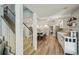 View of kitchen from hallway and stairs, showcasing an open floor plan with plenty of natural light at 13945 75Th Ave, Seminole, FL 33776