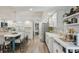 Bright kitchen featuring white cabinets, stainless steel appliances, a large island and coffee bar at 13945 75Th Ave, Seminole, FL 33776