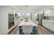 Well-lit kitchen showcases white cabinetry, stainless steel appliances, and a spacious center island with seating at 13945 75Th Ave, Seminole, FL 33776