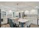 Updated kitchen featuring an island with seating, stainless steel appliances, and eye-catching backsplash at 13945 75Th Ave, Seminole, FL 33776