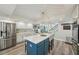 Airy kitchen features white cabinets, stainless steel appliances, an island and lots of counter space at 13945 75Th Ave, Seminole, FL 33776