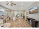 Spacious living room with a large entertainment center and hardwood flooring throughout at 13945 75Th Ave, Seminole, FL 33776