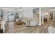 Spacious living room boasts wood floors, a large sectional couch, and a view of the dining area at 13945 75Th Ave, Seminole, FL 33776