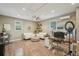 Bright living room featuring hardwood floors, a ceiling fan, and plenty of natural light at 13945 75Th Ave, Seminole, FL 33776