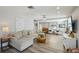 Large living room with wood floors, comfortable sectional sofa, recessed lights, and decorative ceiling fan at 13945 75Th Ave, Seminole, FL 33776