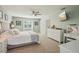 Bright and spacious main bedroom with a connecting bathroom, featuring plush carpeting and plenty of natural light at 13945 75Th Ave, Seminole, FL 33776