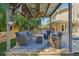 Stylish outdoor living space with comfortable seating, ceiling fans, and a view of the pool area at 13945 75Th Ave, Seminole, FL 33776