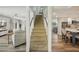 View of the staircase connecting the two floors, with living room and kitchen visible from the landing at 13945 75Th Ave, Seminole, FL 33776