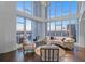 Elegant living room with floor-to-ceiling windows, dark wood floors, and modern furnishings at 175 1St S St # 3402, St Petersburg, FL 33701