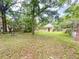 Leafy backyard with shed, swing set and full fence for privacy at 262 Pryor St, Brooksville, FL 34601
