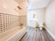 Clean bathroom featuring patterned tiles, bathtub, and modern fixtures at 262 Pryor St, Brooksville, FL 34601