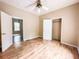 Bedroom showcasing wood look flooring, ceiling fan, and open closet at 262 Pryor St, Brooksville, FL 34601