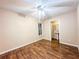 Neutral bedroom featuring wood look floors, ceiling fan, and bathroom access at 262 Pryor St, Brooksville, FL 34601