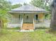 Charming home boasting a cozy front porch with classic railings and a lush green lawn at 262 Pryor St, Brooksville, FL 34601