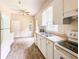 Traditional kitchen featuring wood look flooring, double basin sink, and white appliances at 262 Pryor St, Brooksville, FL 34601