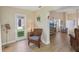 Inviting living area with cozy wicker chair, music stand, and view to backyard at 3340 Mcmath Dr, Palm Harbor, FL 34684