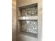 Close up on bathroom shelves featuring stylish tile and recessed lighting for a modern touch at 5321 Dover Ne St, St Petersburg, FL 33703