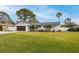 Charming single-story home with a well-manicured lawn and landscaping at 5321 Dover Ne St, St Petersburg, FL 33703