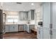 Charming kitchen featuring blue cabinets, stainless steel appliances, and wood-look flooring at 5321 Dover Ne St, St Petersburg, FL 33703