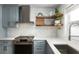 Modern kitchen featuring shaker style cabinets, stainless steel appliances, and stone countertops at 5321 Dover Ne St, St Petersburg, FL 33703