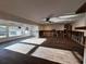 Open living room with wood-look floors, a ceiling fan, and many windows to let in natural light at 5321 Dover Ne St, St Petersburg, FL 33703