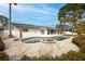 Private pool with jacuzzi, surrounded by a brick patio, ideal for relaxing outdoors at 5321 Dover Ne St, St Petersburg, FL 33703