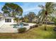 Inviting pool with spa and umbrella stand surrounded by lush landscaping and a paver patio at 5321 Dover Ne St, St Petersburg, FL 33703
