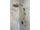 Modern bathroom shower with marble tiling, gold fixtures, and a gold rainfall shower head at 5321 Dover Ne St, St Petersburg, FL 33703