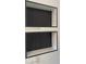 Bathroom features a black hexagon-tiled shower niche inside of the marble-tiled shower at 5321 Dover Ne St, St Petersburg, FL 33703