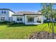 Backyard with covered patio and lush green grass at 6233 Golden Beach Dr, Apollo Beach, FL 33572