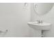 Simple bathroom featuring a pedestal sink, round mirror, and chrome fixtures for a clean and functional design at 6233 Golden Beach Dr, Apollo Beach, FL 33572