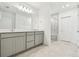 Elegant bathroom features a double vanity with quartz countertop and a glass-enclosed walk-in shower at 6233 Golden Beach Dr, Apollo Beach, FL 33572