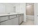 Modern bathroom with double sinks, gray cabinets, a large mirror, and a shower-tub combination at 6233 Golden Beach Dr, Apollo Beach, FL 33572
